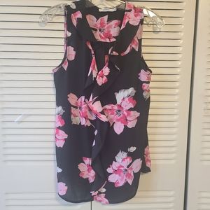 NWOT Black w pink floral design. Sleeveless summer chiffon top w ruffled front.
